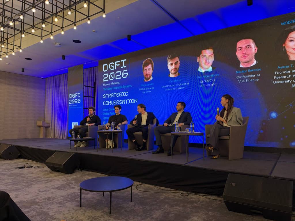 Wide view of the Local Currency, Global Rails panel and moderator during Day 1.